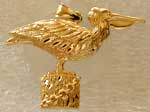 gold pelican on piling