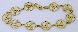 new grange spiral triskelle bracelet in 14kt polished gold and enamel